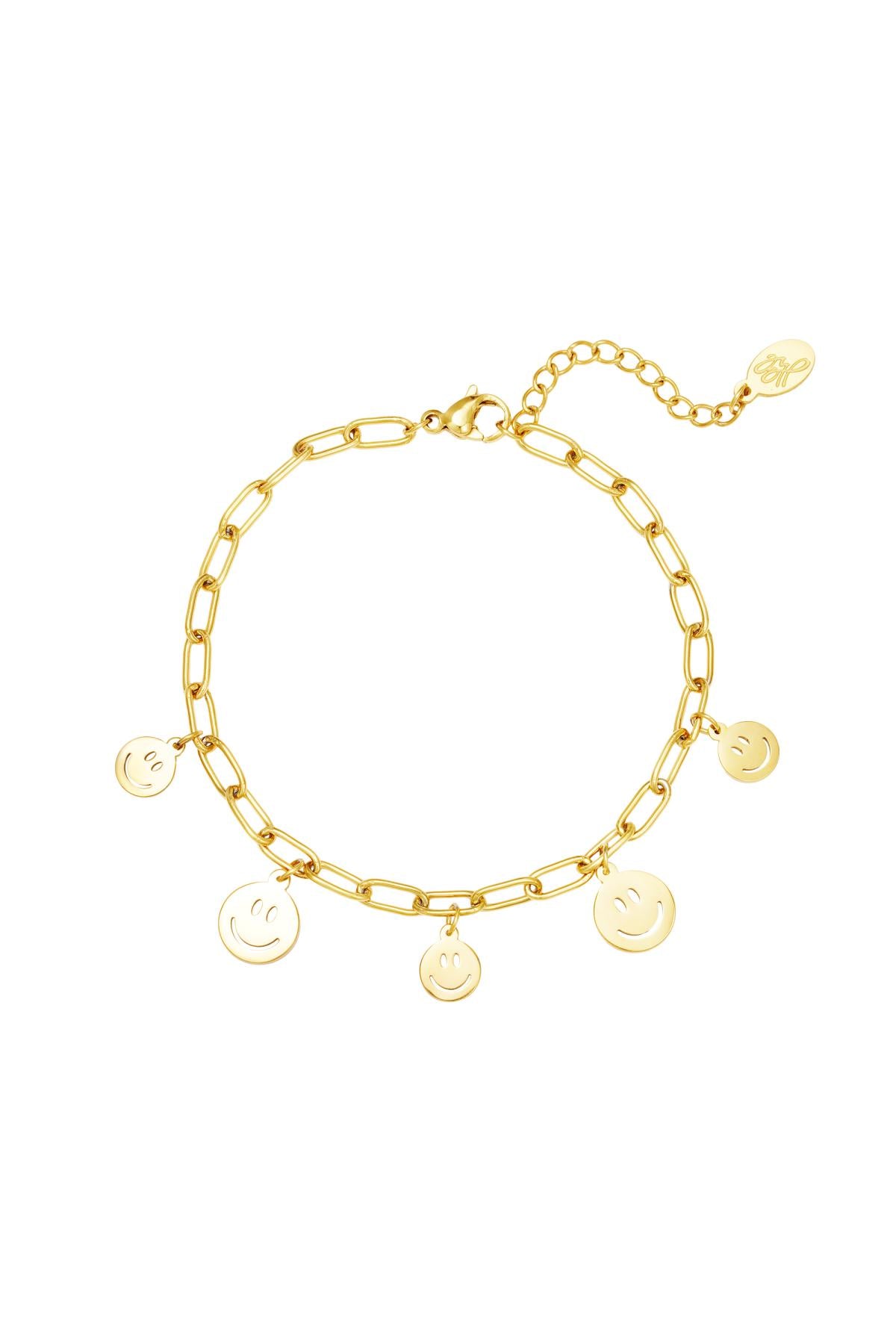 Gold tone link chain bracelet with five dangling smiley face charms and lobster clasp on white background
