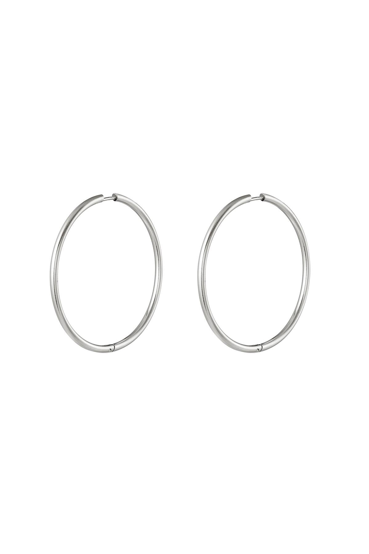 Pair of classic silver hoop earrings with smooth, thin design and secure clasp on white background