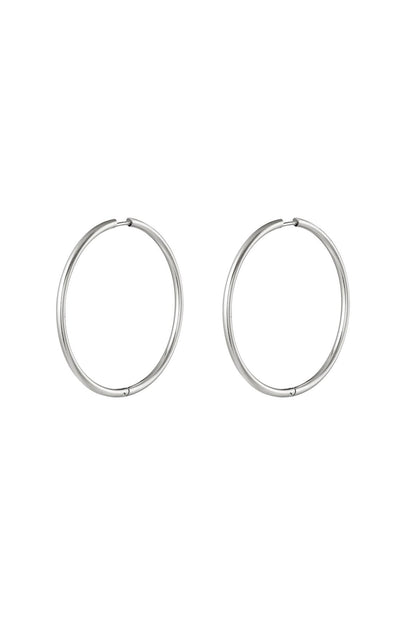Pair of classic silver hoop earrings with smooth, thin design and secure clasp on white background