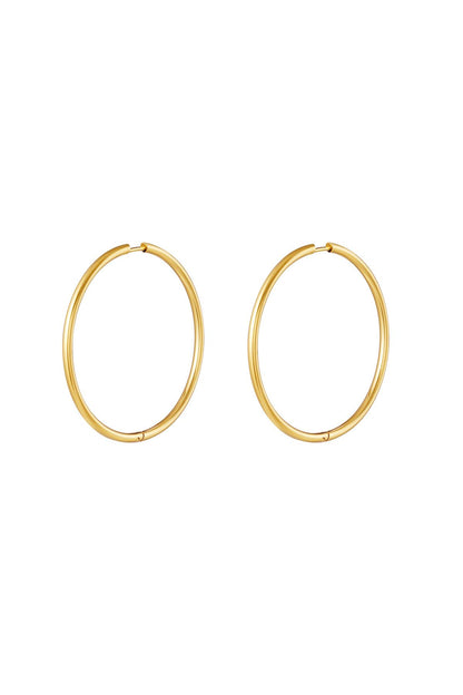 Pair of classic gold hoop earrings with smooth, thin design and secure clasp on white background