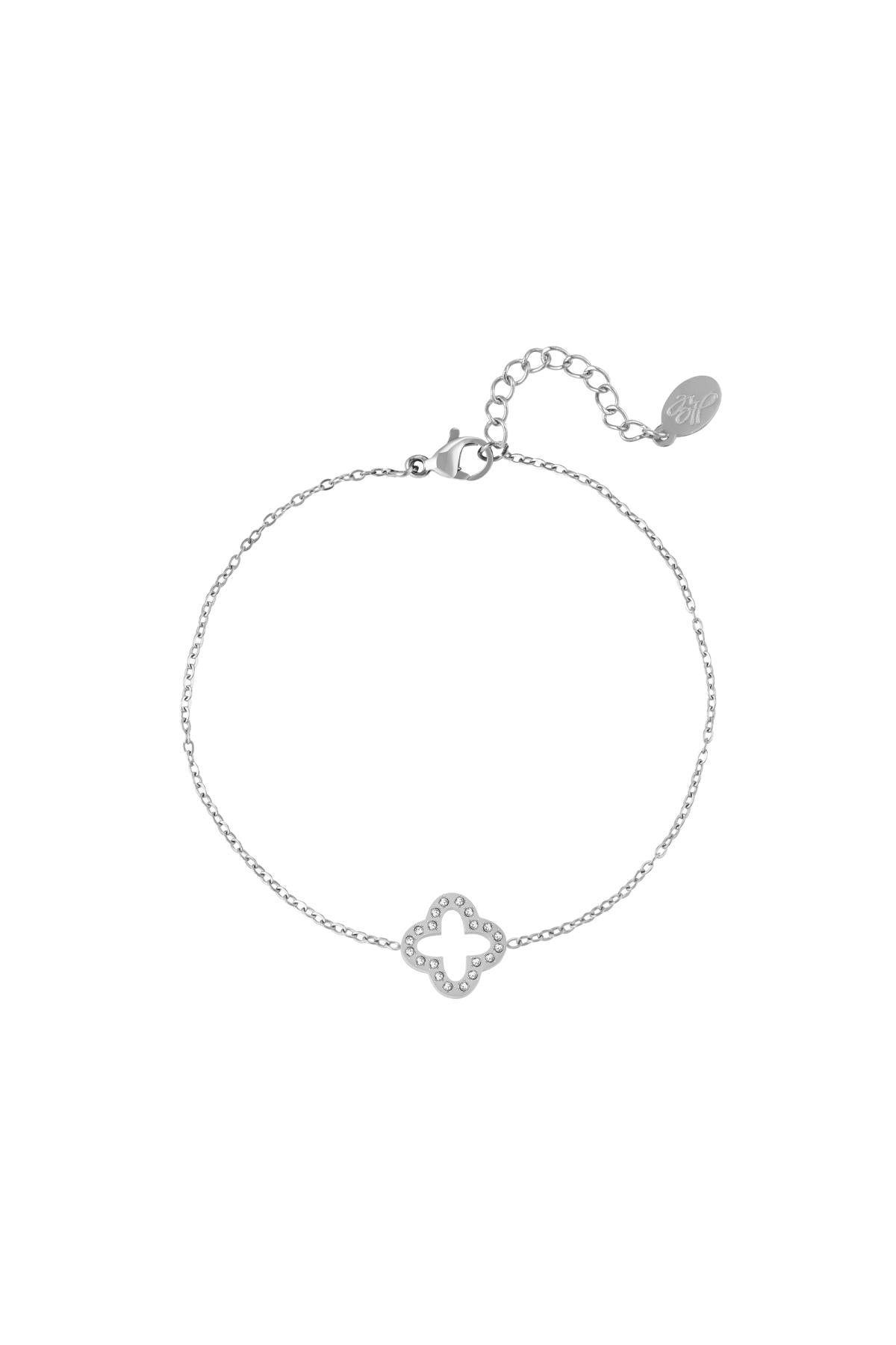 Silver clover charm bracelet with sparkling zircon stones and adjustable chain clasp on white background