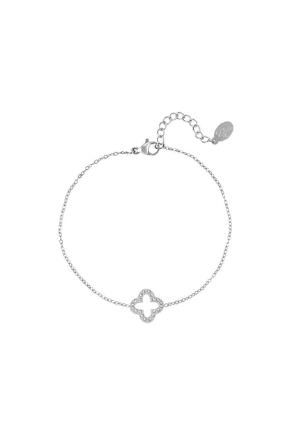 Silver clover charm bracelet with sparkling zircon stones and adjustable chain clasp on white background