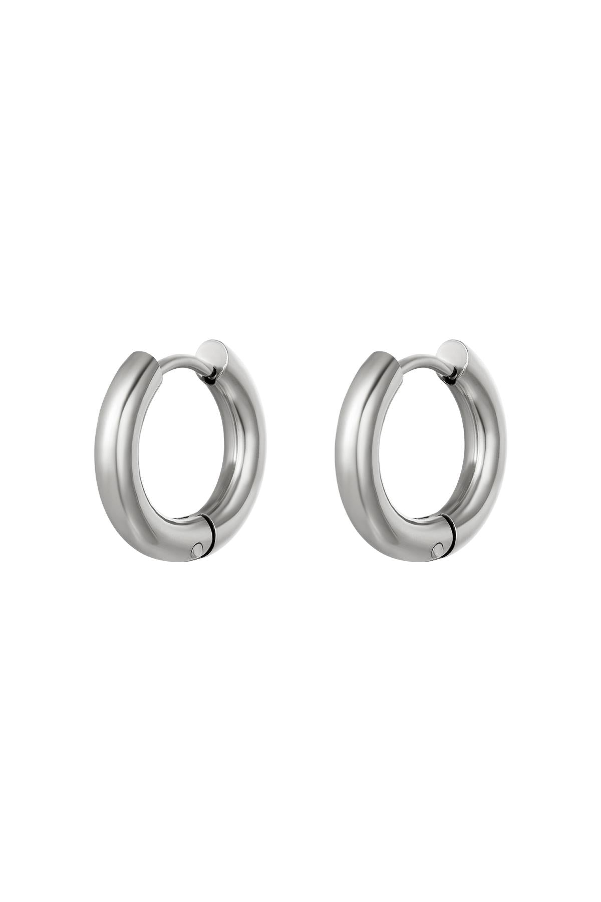 Pair of chunky silver hoop earrings with a sleek polished design