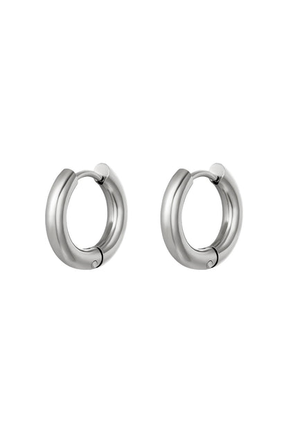 Pair of chunky silver hoop earrings with a sleek polished design