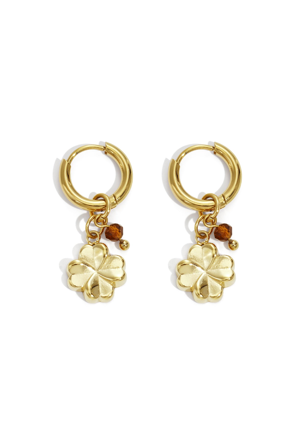 Close-up of gold hoop earrings with four-leaf clover charms and brown faceted bead accents shown on white background