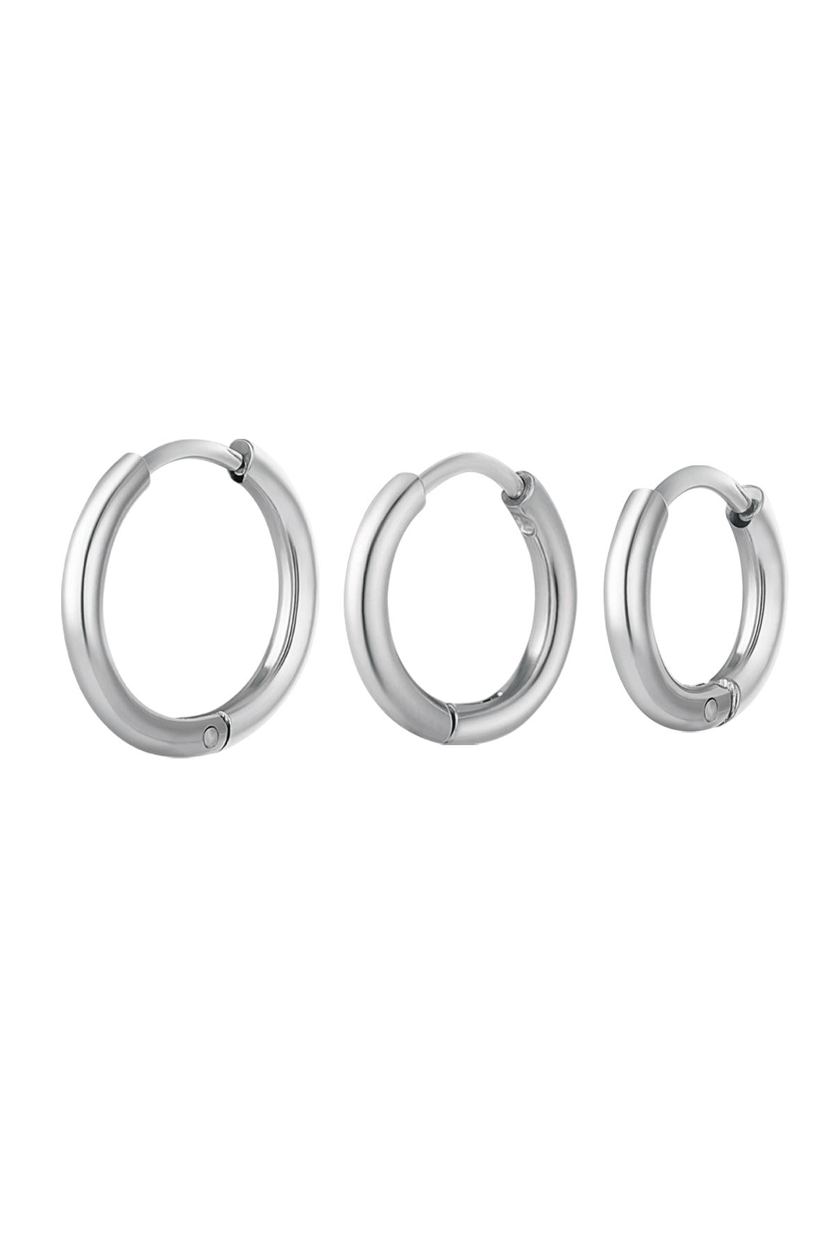 Set of three smooth polished silver hoop earrings in small, medium, and large sizes on white background