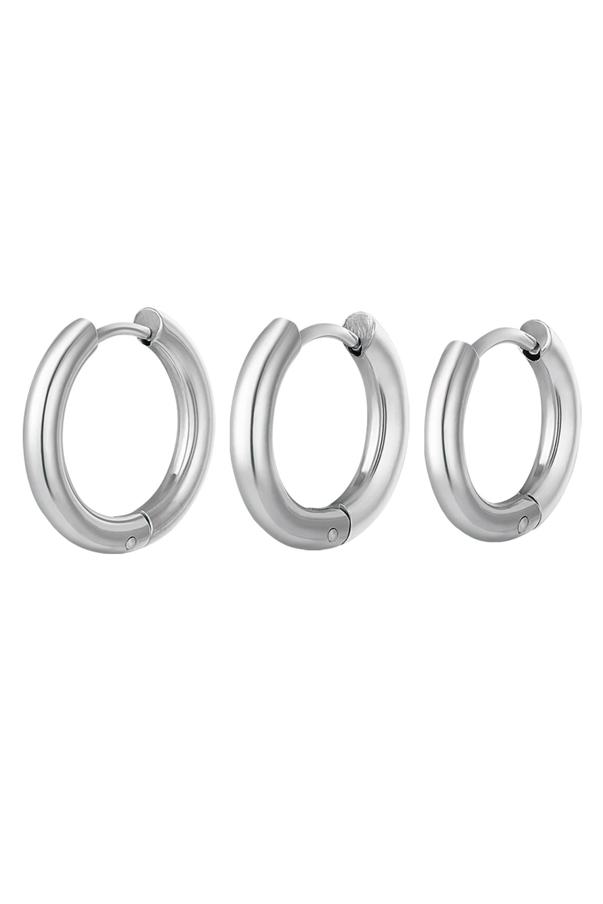 Set of three smooth polished silver hoop earrings in small, medium, and large sizes on white background angled differently