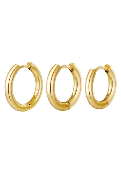 Set of three smooth polished gold hoop earrings in small, medium, and large sizes on white background