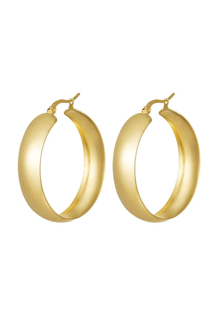 Pair of bold, wide gold hoop earrings with a smooth curved design on a white background