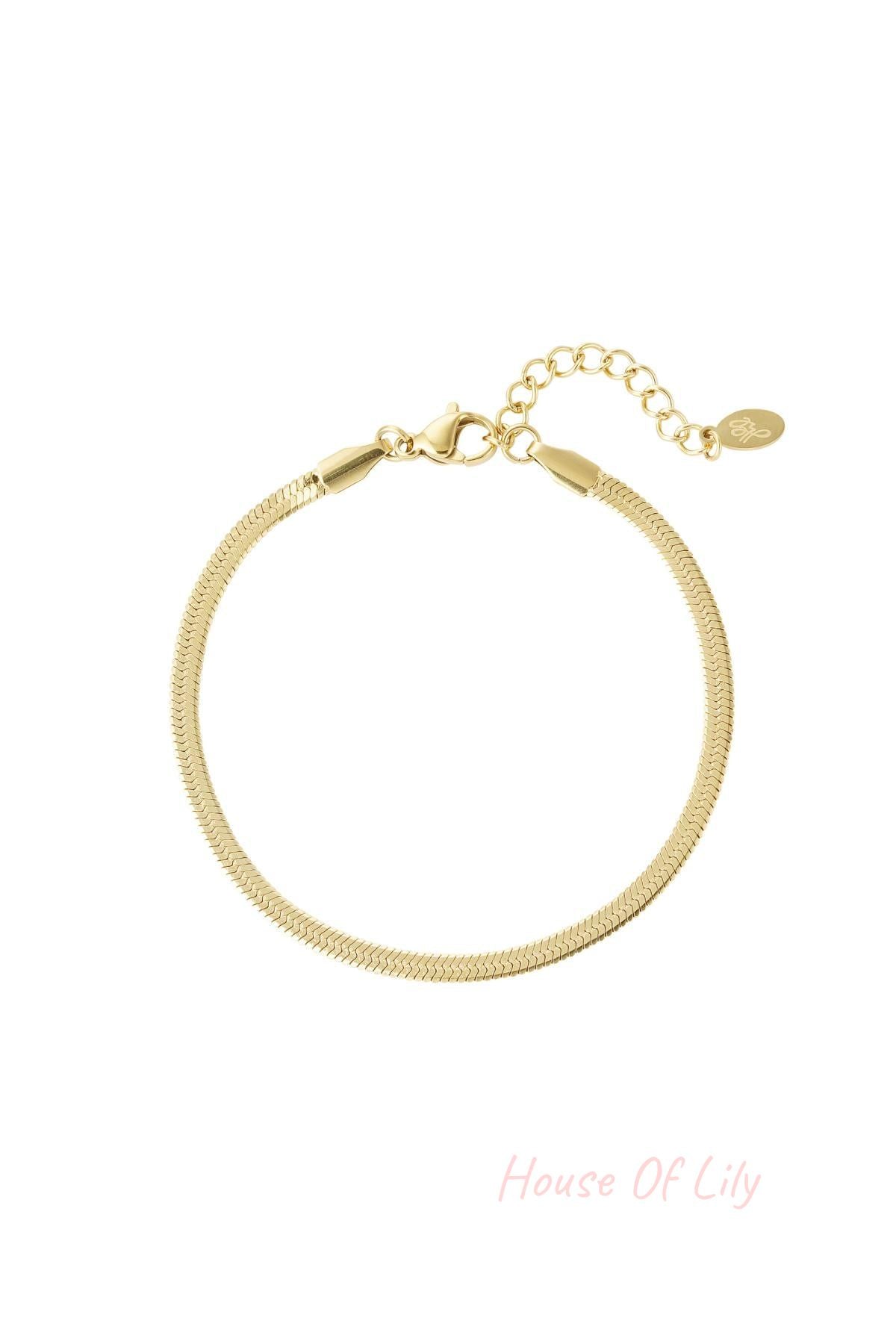 Close-up of a gold-tone herringbone chain bracelet with lobster clasp and adjustable extension chain on a white background
