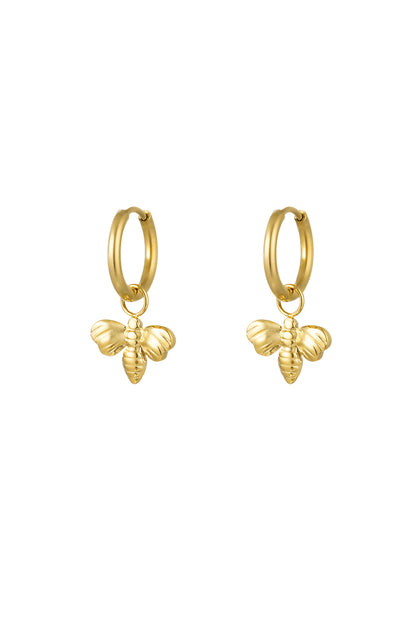 Pair of gold bee charm hoop earrings on white background