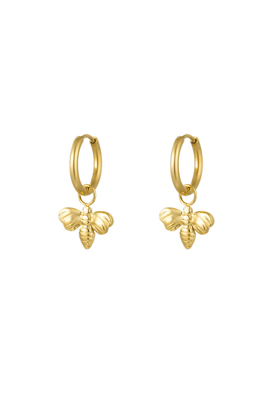 Pair of gold bee charm hoop earrings on white background