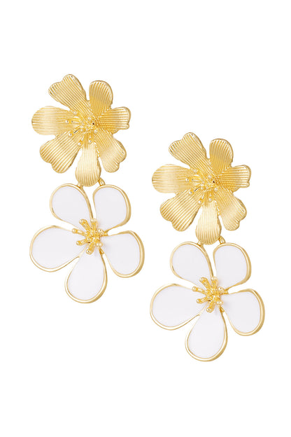 Pair of gold-tone drop earrings with textured top flower and black enamel bottom flower close-up on white background
