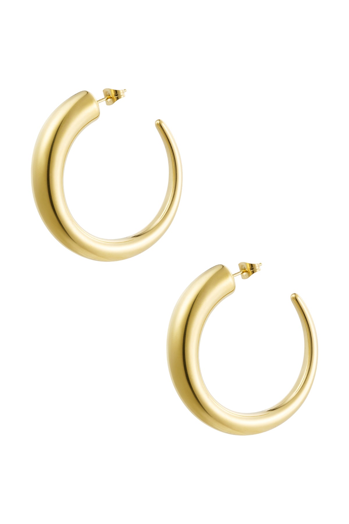 Pair of chunky gold curved hoop earrings on white background