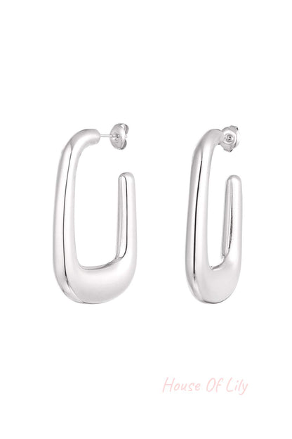 Dreamy Cloud Hoops: Silver-toned, polished U-shaped hoop earrings with a thick, modern, chunky design.