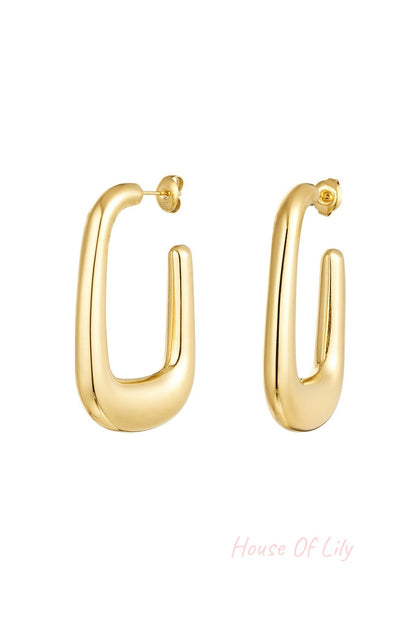 Pair of chunky gold-tone minimalist hoop earrings displayed on white background