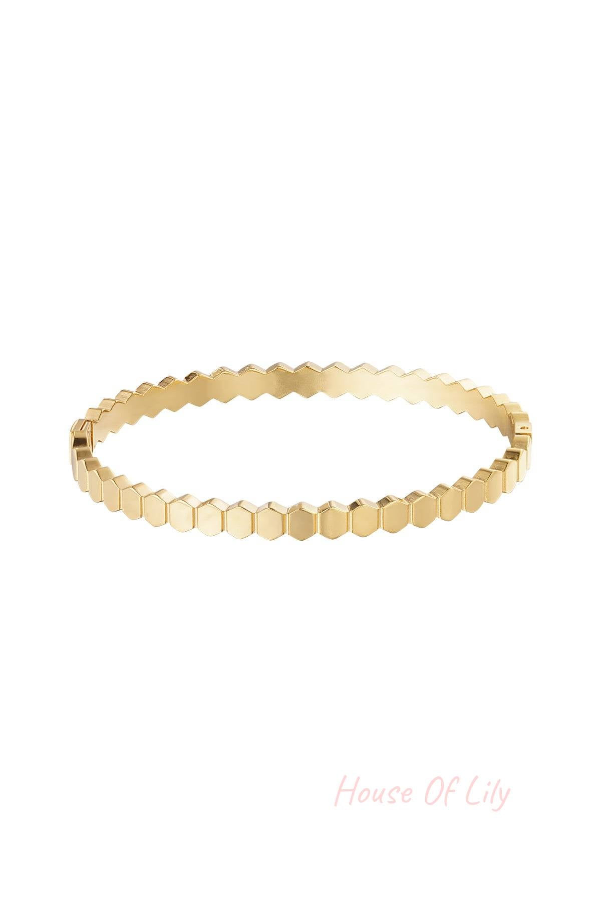 Close-up of gold hexagon link bracelet with polished finish on white background