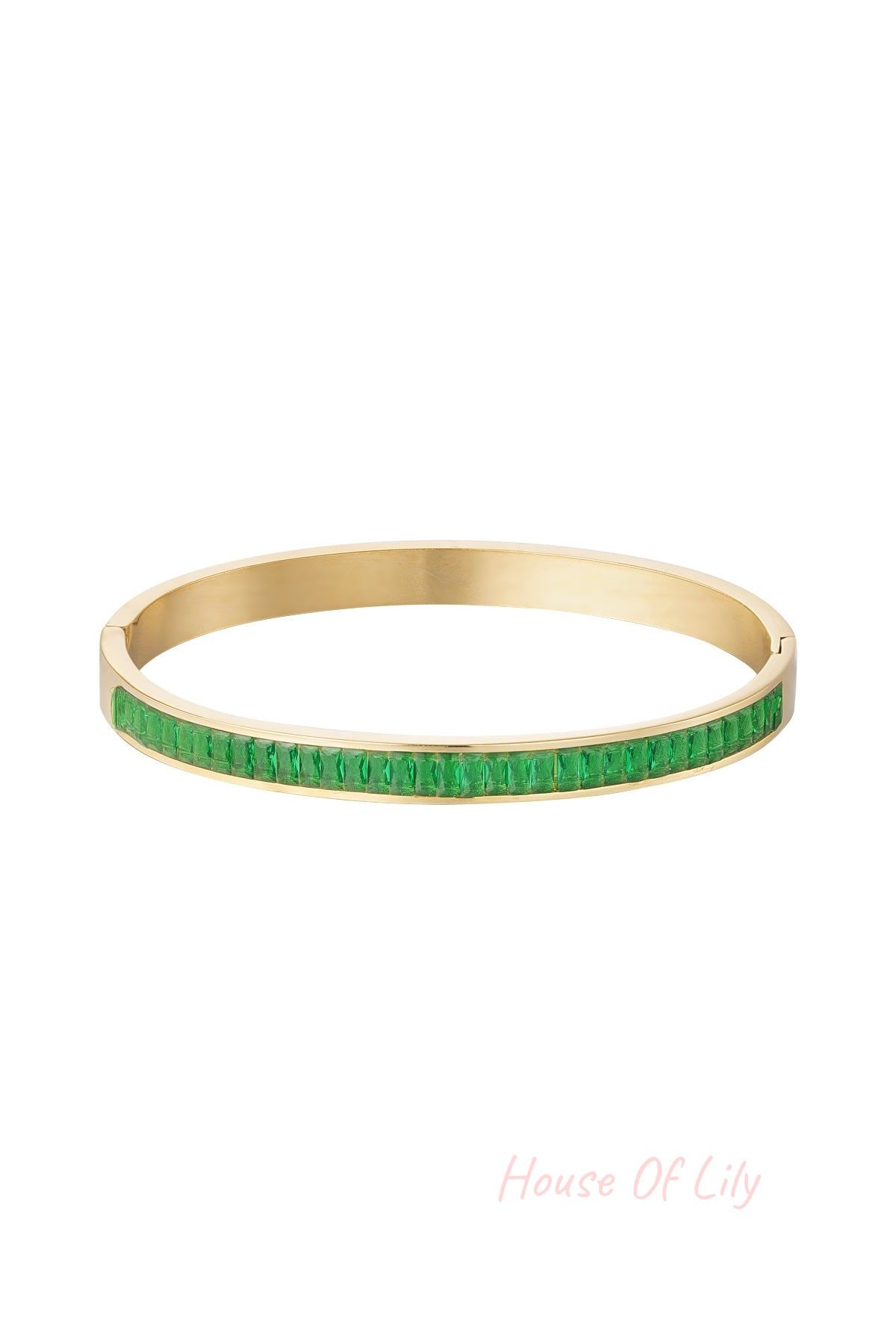 Gold-tone bangle bracelet with bright green square-cut crystal stones displayed on white background
