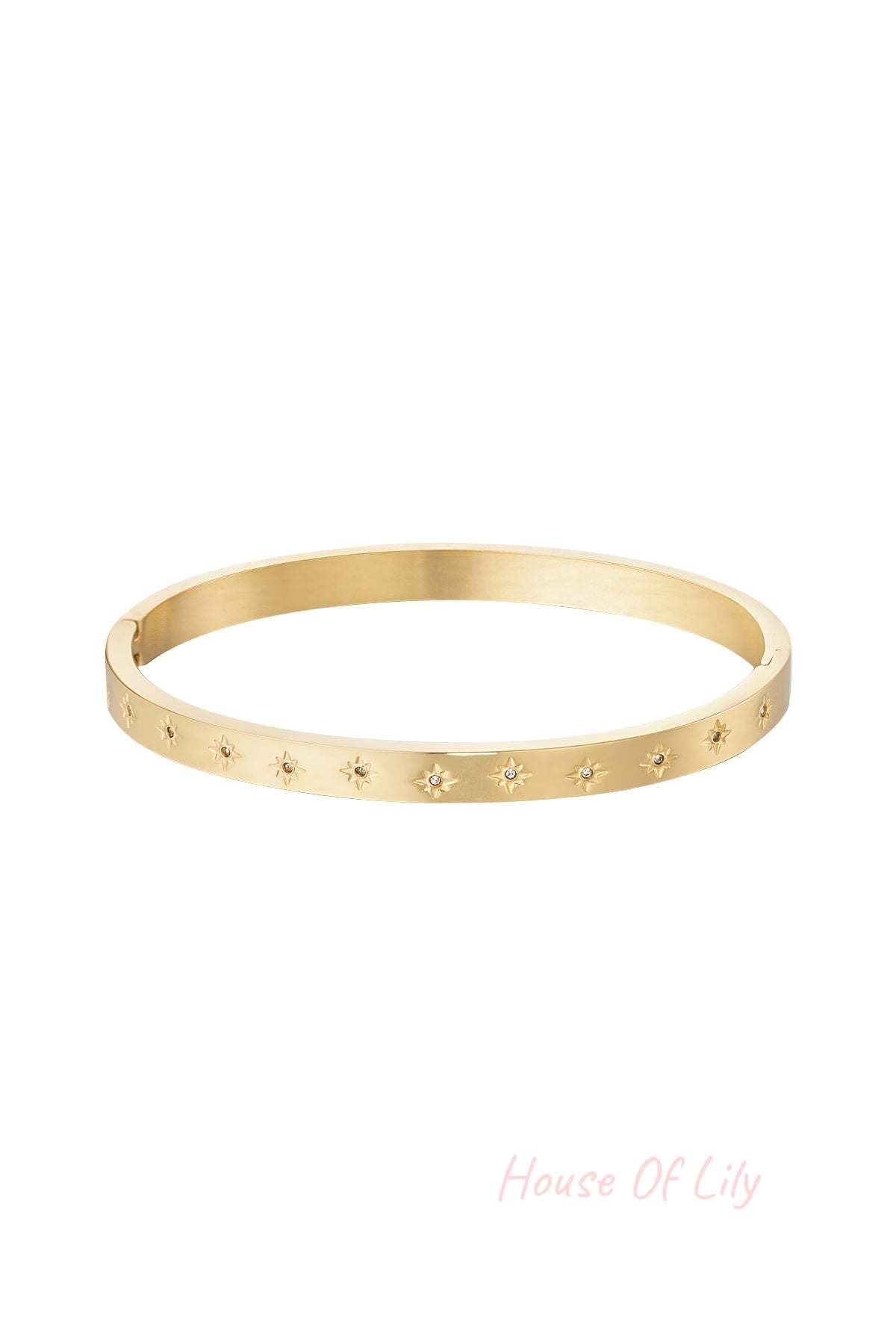 Gold-tone slim bangle bracelet adorned with star motifs and small sparkling stones on white background