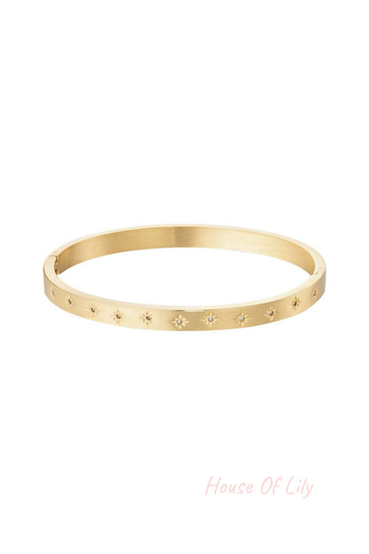 Gold-tone slim bangle bracelet adorned with star motifs and small sparkling stones on white background
