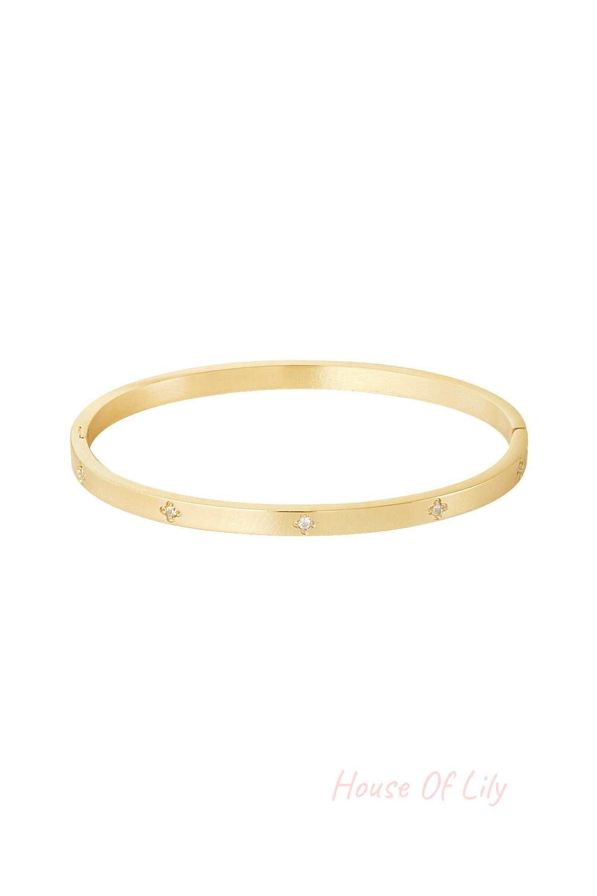 Minimalist gold bangle bracelet with small sparkling stone accents