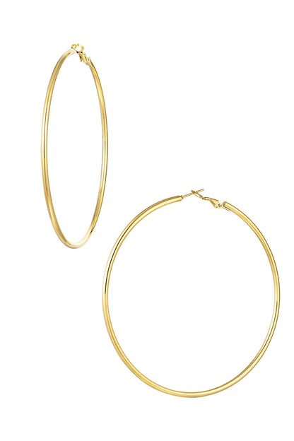 Close-up image of shiny, smooth gold plated large hoop earrings set against white background