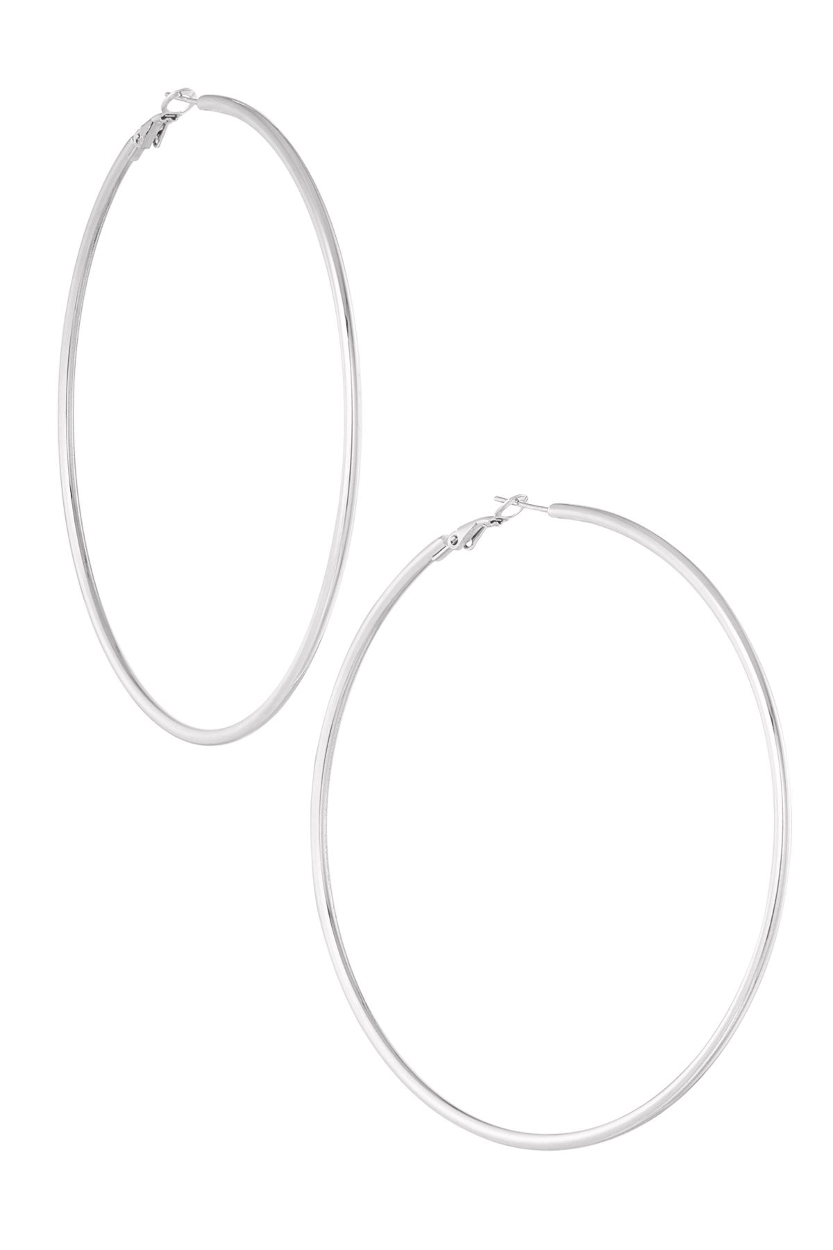 Pair of large thin silver hoop earrings shown against white background