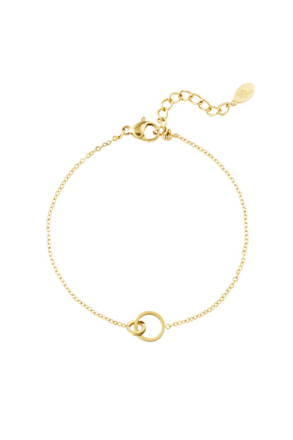 Gold-tone delicate bracelet with two interlinked circular charms and adjustable chain clasp on a white background