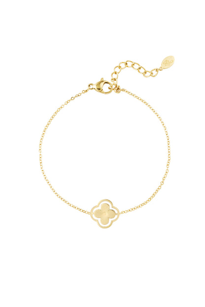 Gold double clover charm bracelet on white background showing delicate chain and adjustable clasp