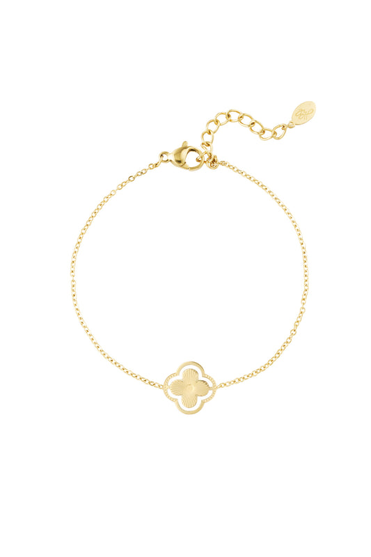 Gold double clover charm bracelet on white background showing delicate chain and adjustable clasp