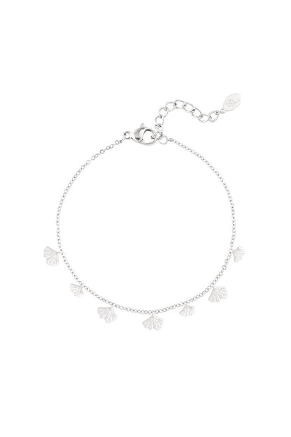 Silver charm bracelet featuring delicate ginkgo leaf charms on a fine chain with lobster clasp