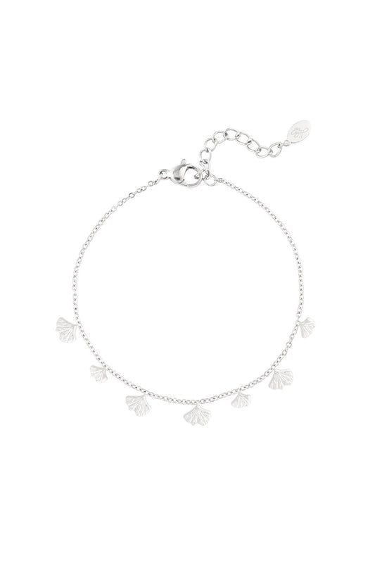 Silver charm bracelet featuring delicate ginkgo leaf charms on a fine chain with lobster clasp