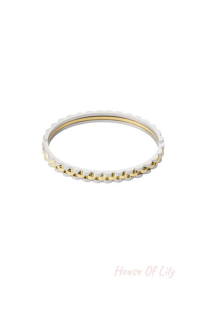 Two-tone scalloped edge bracelet combining silver and gold tones shown isolated on white