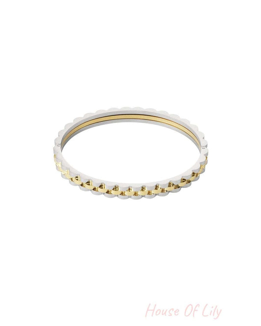 Two-tone scalloped edge bracelet combining silver and gold tones shown isolated on white