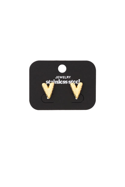 Gold textured heart-shaped stud earrings mounted on black display card labeled stainless steel jewelry