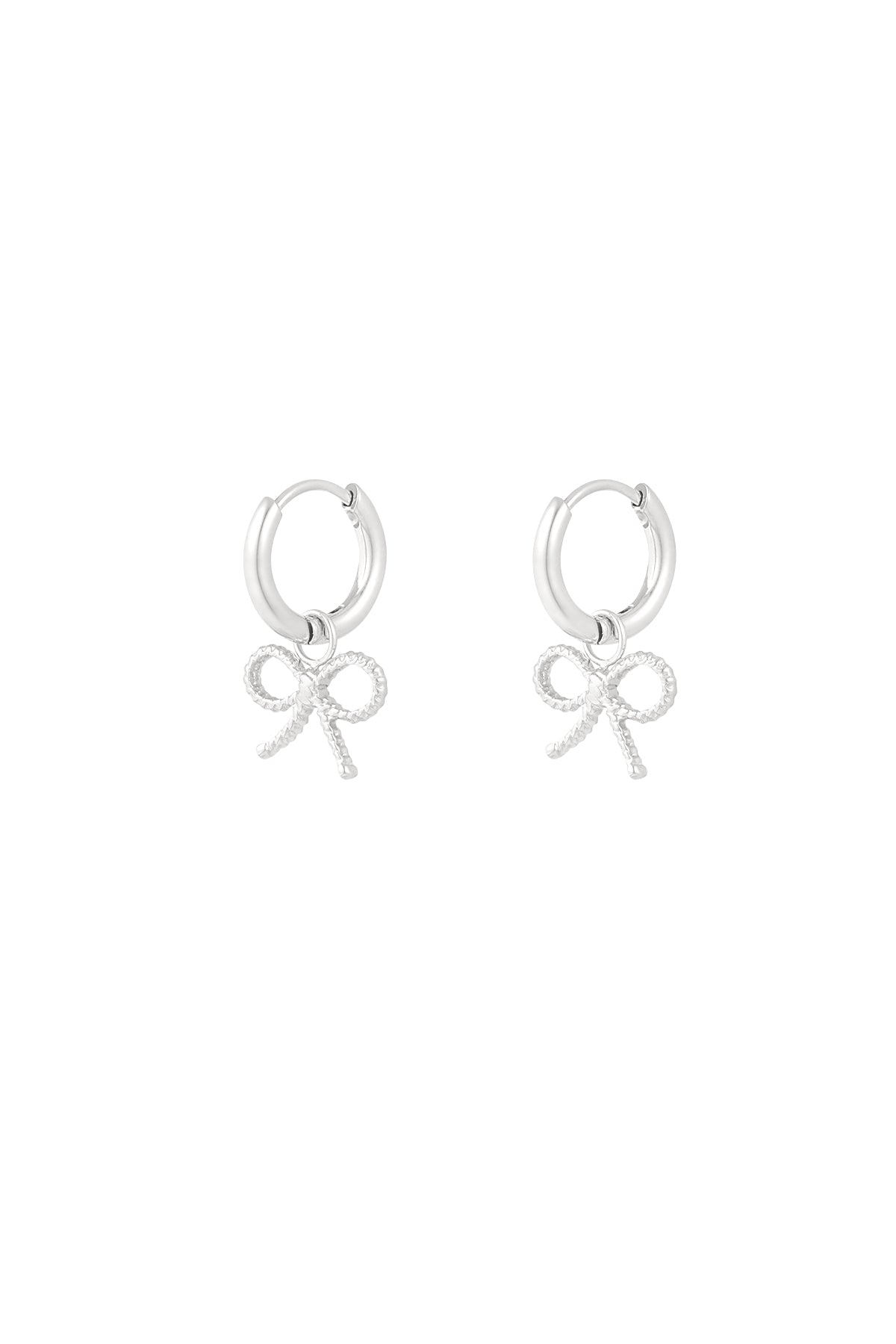 Pair of silver hoop earrings with textured bow charms on white background