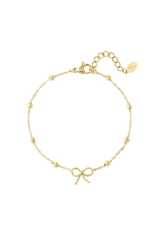 Gold-tone delicate bow charm bracelet with small spherical beads and adjustable chain on white background