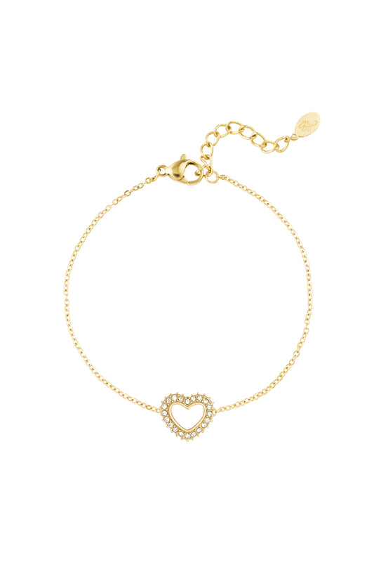 Gold-tone delicate heart charm bracelet with rhinestones and adjustable chain on a white background