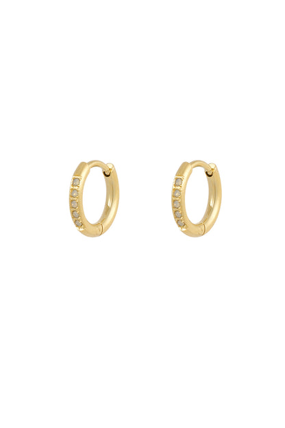 Small gold hoop earrings featuring a row of delicate, light-colored opal stones. Minimalist, elegant jewelry style.