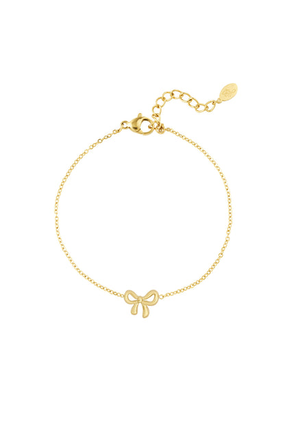 Gold bow charm bracelet with delicate chain and lobster clasp on white background