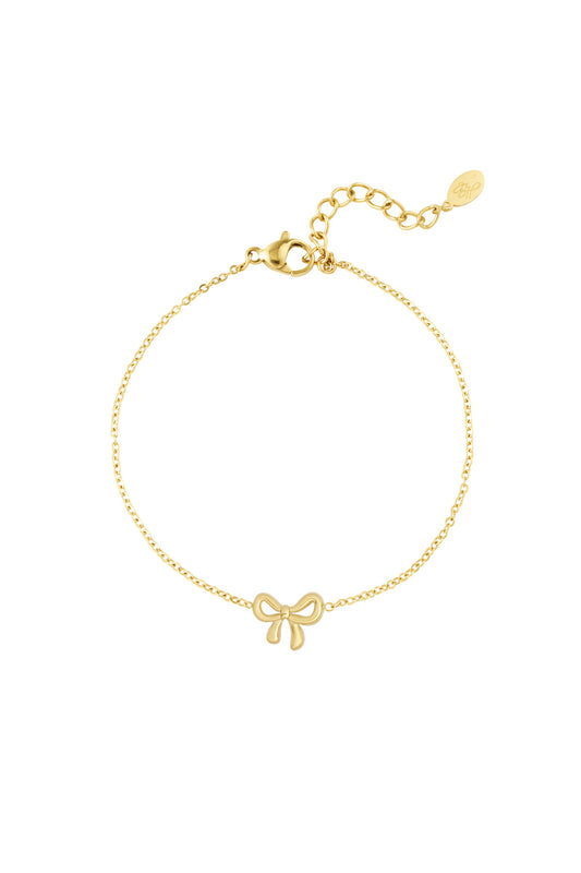Gold bow charm bracelet with delicate chain and lobster clasp on white background