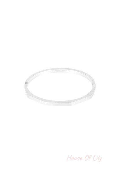 Silver hexagon-shaped bangle bracelet with a matte finish displayed on white background