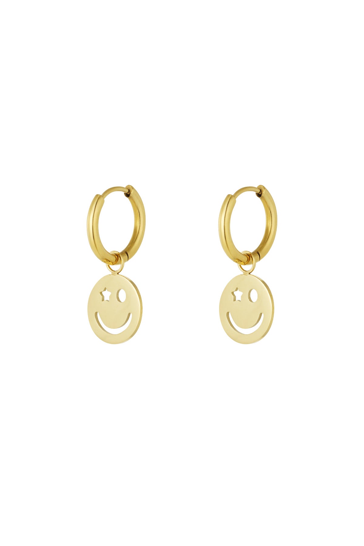 Pair of gold hoop earrings with dangling smiley face charm featuring one star eye and one circular eye on white background
