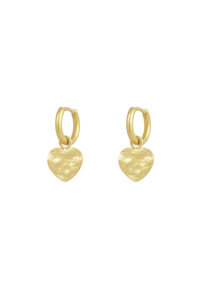 Gold textured heart hoop earrings on white background