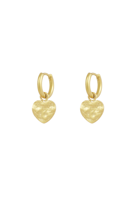 Gold textured heart hoop earrings on white background