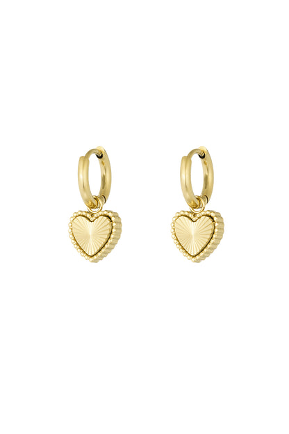 Pair of gold-tone stainless steel hoop earrings with textured heart-shaped charms on a white background