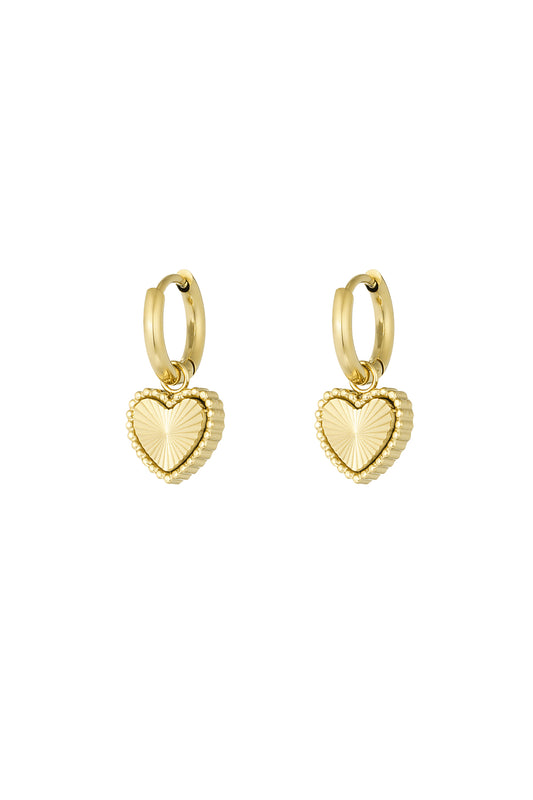 Pair of gold-tone stainless steel hoop earrings with textured heart-shaped charms on a white background