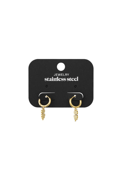 Gold-tone four-leaf clover hoop earrings on black jewellery card labelled stainless steel