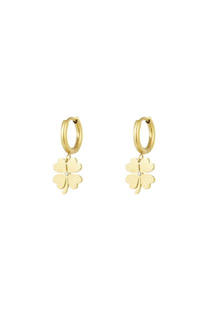 Pair of gold-tone stainless steel hoop earrings with dangling four-leaf clover charms featuring crystal detail