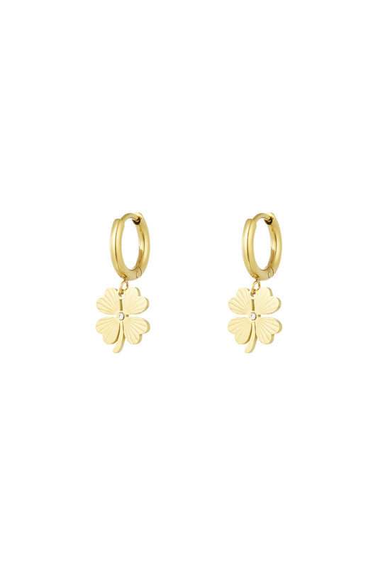 Pair of gold-tone stainless steel hoop earrings with dangling four-leaf clover charms featuring crystal detail